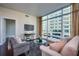 Bright living room with floor-to-ceiling windows and comfortable seating arrangement at 101 S Eola Dr # 621, Orlando, FL 32801