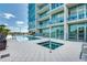 Beautiful pool and jacuzzi on a deck with lounge chairs and a modern condo building in the background at 101 S Eola Dr # 621, Orlando, FL 32801
