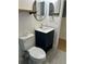 Modern bathroom featuring blue vanity and minimalist design at 1040 N Clayton St, Mount Dora, FL 32757