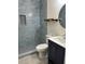 Modern bathroom featuring stylish blue tiling, a tiled shower niche, and sleek vanity at 1040 N Clayton St, Mount Dora, FL 32757