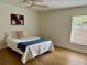 Cozy bedroom with neutral tones, a comfortable bed, and natural light at 1040 N Clayton St, Mount Dora, FL 32757