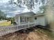 Charming single-story home featuring a picket fence and well-manicured lawn at 1040 N Clayton St, Mount Dora, FL 32757