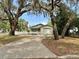 A charming single story home with mature landscaping and a white picket fence at 1040 N Clayton St, Mount Dora, FL 32757