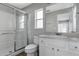 Bathroom with glass shower, white vanity, and tile floors at 1175 Seasons Blvd, Kissimmee, FL 34746