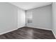 A bedroom with wood floors, a window with blinds and a closet with white doors at 1175 Seasons Blvd, Kissimmee, FL 34746