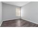 Cozy bedroom featuring wood floors and a window at 1175 Seasons Blvd, Kissimmee, FL 34746