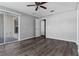 Large bedroom featuring sliding glass door to balcony, and wood floors at 1175 Seasons Blvd, Kissimmee, FL 34746