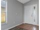 A bright foyer featuring tile floors and a white front door with sidelight window at 1175 Seasons Blvd, Kissimmee, FL 34746
