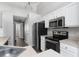 Close-up of kitchen featuring stainless steel appliances and white cabinets at 1175 Seasons Blvd, Kissimmee, FL 34746