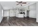 Open-concept living room featuring wood floors and neutral paint throughout at 1175 Seasons Blvd, Kissimmee, FL 34746