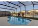 Sparkling screened-in pool with clear water and spacious surrounding patio area at 1175 Seasons Blvd, Kissimmee, FL 34746
