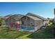 A screened in pool in a backyard with a manicured lawn on a sunny day at 1175 Seasons Blvd, Kissimmee, FL 34746