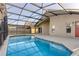 A refreshing screened-in pool with a spacious patio, perfect for entertaining at 1175 Seasons Blvd, Kissimmee, FL 34746