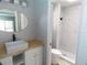 Bright bathroom features an oval mirror, modern sink, and walk-in shower at 131 Lake Charles Rd, Deland, FL 32724