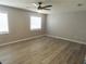 Bright bedroom features sleek ceiling fan, wood-look floors, and abundant natural light at 131 Lake Charles Rd, Deland, FL 32724