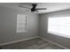 Bright bedroom features wood-look floors, a built-in shelf and ceiling fan at 131 Lake Charles Rd, Deland, FL 32724