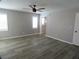 Spacious bedroom features sleek ceiling fan, wood-look floors, and abundant natural light at 131 Lake Charles Rd, Deland, FL 32724