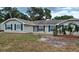 Charming single-story home featuring neutral siding, dark shutters, manicured landscaping and a well-maintained lawn at 131 Lake Charles Rd, Deland, FL 32724