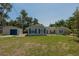 Charming single-story home with a detached garage and a well-maintained lawn at 131 Lake Charles Rd, Deland, FL 32724