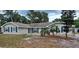 Charming single-story home featuring neutral siding, dark shutters, manicured landscaping and a well-maintained lawn at 131 Lake Charles Rd, Deland, FL 32724