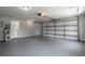 Spacious two-car garage with automatic door, painted floor, and utility access at 131 Lake Charles Rd, Deland, FL 32724