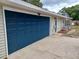 Attached garage featuring a dark blue door and convenient access to the home at 131 Lake Charles Rd, Deland, FL 32724