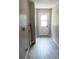 Clean hallway features wood-look floors and leads to the back door at 131 Lake Charles Rd, Deland, FL 32724