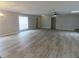 Spacious living room with gray walls, wood-look flooring, lots of natural light and two ceiling fans at 131 Lake Charles Rd, Deland, FL 32724