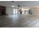 Open-concept living room featuring a stone fireplace, ceiling fan, skylights, gray walls, and wood-look flooring at 131 Lake Charles Rd, Deland, FL 32724