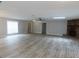 Spacious living room with gray walls, wood-look flooring, lots of natural light and a stone fireplace at 131 Lake Charles Rd, Deland, FL 32724