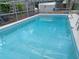 In-ground swimming pool with an enclosure and ladder for access at 131 Lake Charles Rd, Deland, FL 32724