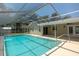 Sparkling pool with screened enclosure and a covered lanai at 131 Lake Charles Rd, Deland, FL 32724