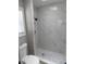 This bathroom features a modern shower with decorative stone flooring and tile walls at 131 Lake Charles Rd, Deland, FL 32724