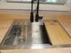 Close up view of a modern kitchen sink with a cutting board, sleek faucet and a bright window at 131 Lake Charles Rd, Deland, FL 32724