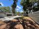 Expansive backyard featuring a large in-ground pool, covered patio, storage shed, and a tall privacy fence at 1329 Se 36Th Ave, Ocala, FL 34471