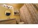 Bathroom featuring a decorative shower curtain, white vanity, and illuminated mirror at 1329 Se 36Th Ave, Ocala, FL 34471