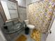 Clean bathroom featuring glass sink, commode, a sunflower shower curtain, and tiled wall and floor at 1329 Se 36Th Ave, Ocala, FL 34471