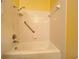 Clean white bathtub and tile bathroom with a shower and hand rails for accessibility at 1329 Se 36Th Ave, Ocala, FL 34471
