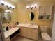 Bright bathroom features a vanity with storage, a toilet, and dual light fixtures at 1329 Se 36Th Ave, Ocala, FL 34471