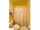 Bright bathroom features a toilet, and a shower with patterned curtain at 1329 Se 36Th Ave, Ocala, FL 34471