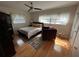 Bright bedroom with wood floors, a bed, ceiling fan and a seating area at 1329 Se 36Th Ave, Ocala, FL 34471