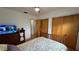 Bedroom features a bed, chest of drawers with TV, wood flooring, and a closet at 1329 Se 36Th Ave, Ocala, FL 34471