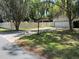 A charming home with a well-manicured lawn, mature trees, and a driveway leading to an attached two-car garage at 1329 Se 36Th Ave, Ocala, FL 34471