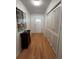 Entryway with hardwood flooring, artwork and doors to storage at 1329 Se 36Th Ave, Ocala, FL 34471