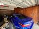 Organized garage featuring a sleek blue car and a silver SUV at 1329 Se 36Th Ave, Ocala, FL 34471