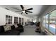 A spacious living room with multiple seating areas and abundant natural light, enhanced by modern ceiling fans at 1329 Se 36Th Ave, Ocala, FL 34471