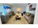 Cozy living area with large television, couch and open to the dining room at 1329 Se 36Th Ave, Ocala, FL 34471