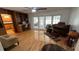 Sunlit living room featuring hardwood floors, built-in shelves, and French doors to additional seating areas at 1329 Se 36Th Ave, Ocala, FL 34471