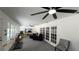 Large living room featuring a ceiling fan, French doors, a television, and a comfortable seating area at 1329 Se 36Th Ave, Ocala, FL 34471