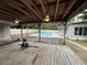 Wooden covered patio with ceiling fans overlooking backyard and pool at 1329 Se 36Th Ave, Ocala, FL 34471